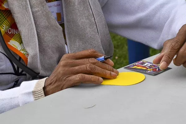 Mains d'une personne âgée jouant avec une carte.